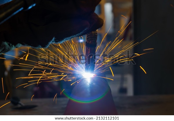 Welding torch close-up. Pipe welding by\
semi-automatic arc welding. MIG\
welding.