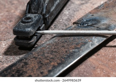Welding torch with electrode and steel workpiece close up. Welding concept background.
 - Powered by Shutterstock - Get 15% off with code: PIKWIZARD15