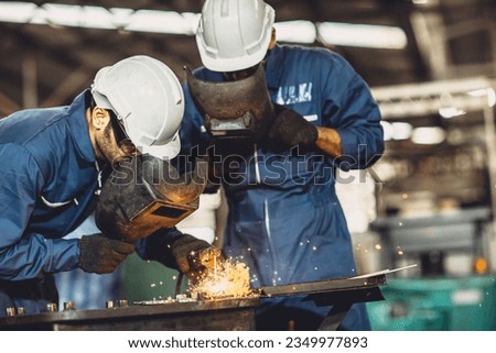 welding worker team working arc weld metal joint production in heavy industry danger and risk workplace with eyes safety equipment