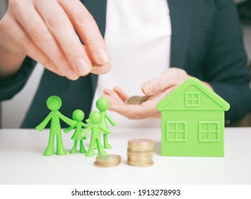 Welfare Benefits Koncept. Hands Of Woman Making A Gesture Of Protection Over Family And Home With Piggy Bank. House Construction And Savings Insurance Concept. Property Insurance And Security Concept