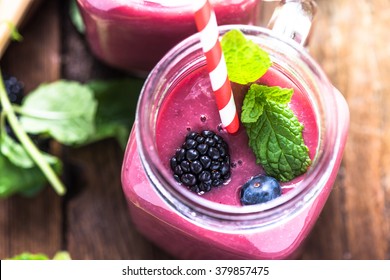 Well being and weight loss concept, berry smoothie.On wooden table with ingredients, from above.