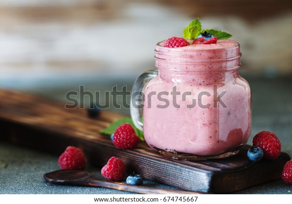 Well being and weight loss concept, berry\
smoothie with fresh raspberry and\
blueberry