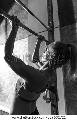 Similar – Image, Stock Photo Rear view portrait of one young middle age athletic woman at crossfit training, exercising with trx suspension fitness straps over dark background