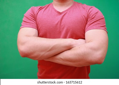 Well built man with muscles on green screen in red shirt - Powered by Shutterstock