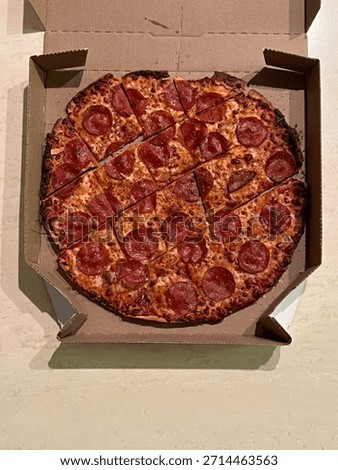 A well cooked pizza in a box