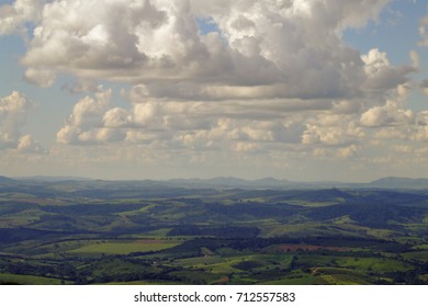 Well defined clouds viewed from the top of a mountain. Blue sky background. Strange clouds conformations. Huge landscape over a beautiful natural lights effect.