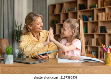 Well Done. Excited Teacher Giving High Five To Little Girl, Greet Schoolgirl For Giving Correct Answer Solving Hard Math Problem, Praise Child For Reaching Success In Homework