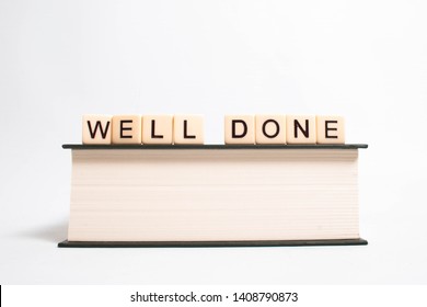 Well Done Graduation Photograph Spelled On Book With Scrabble Letters Isolated White Background