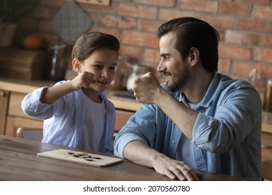 Well Done My Boy. Happy Father Bump Fists With Preteen Son Greet Smart Child With Getting Victory Winning Game Of Draughts. Overjoyed Young Dad Tween Kid Celebrate End Of Interesting Match Of Checkers