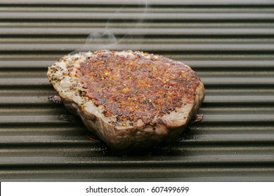 Well Done Steak Steaming On Hot Grill