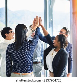 Well Done Team. Cropped Shot Of A Group Of Coworkers High-fiving In The Office.