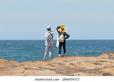 Well Dressed Asian Couple Looking At The Ocean