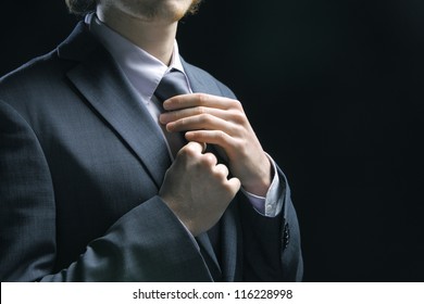 Well Dressed Business Man Adjusting His Neck Tie