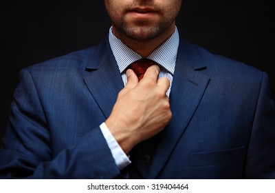 Well Dressed Business Man Adjusting His Neck Tie