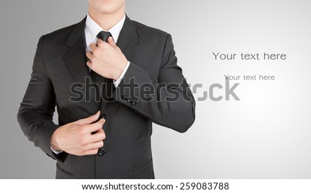 Well dressed businessman looklike smart adjusting  his neck tie : fill text