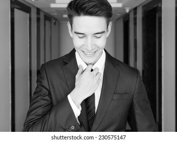 Well dressed male fixing his suite