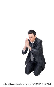 Well Dressed Man Praying On Knees In Studio