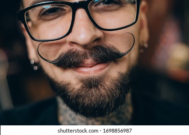 Well groomed hipster. Barbershop concept. Beauty industry. Facial hair care. Mature man bearded hipster with long beard and mustache. Styling mustache. Growing long mustache. Moustache style.