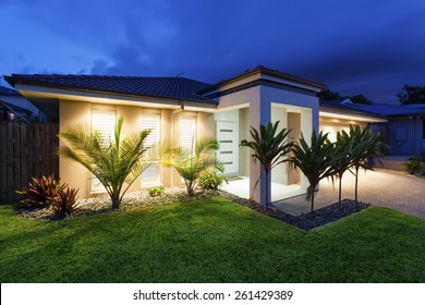 Well lit modern home exterior at dusk