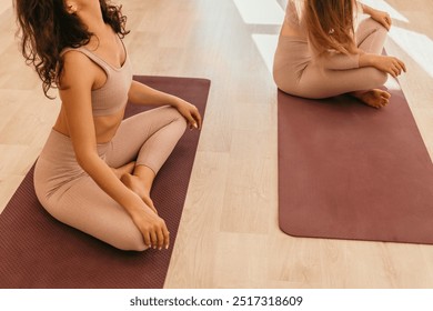 Well looking middle aged sporty woman, fitness instructor in pink sportswear doing stretching and pilates on yoga mat in the studio with mirror. Female fitness yoga. Healthy lifestyle and harmony. - Powered by Shutterstock