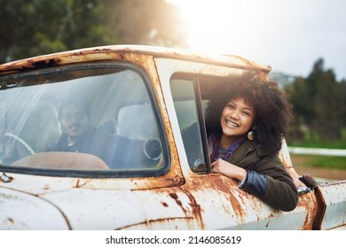 Well Never Stop Exploring. Shot Of A Happy Young Woman Sitting In A Rusty Old Truck.