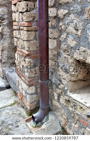 A well preserved lead pipe from within the ancient city of Pompeii, Italy, which was destroyed by the eruption of Mount Vesuvius volcano in 79AD.