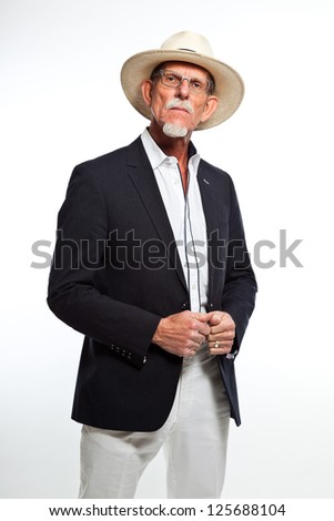 Well summer dressed senior man with hat. Isolated.