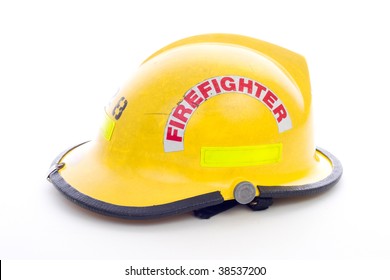 A Well Used Yellow Fire Fighters Helmet On White