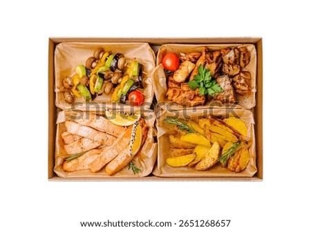 A well-balanced catering box divided into four sections, featuring grilled salmon fillets with lemon, roasted vegetables (zucchini, mushrooms, bell peppers), assorted grilled meats (chicken and beef)