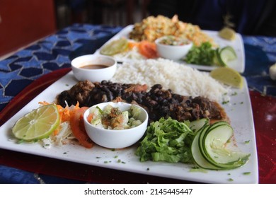 A Well-balanced Meal For Two: Traditional Cuban Dishes In A Restaurant In Havana.