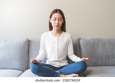 Wellbeing Peaceful Mind Lifestyles,  Young Asian Women Focus On Breath Harmony To Refresh Mindfulness In The Living Room At Home.