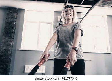 Well-built Senior Woman Holding Battle Ropes