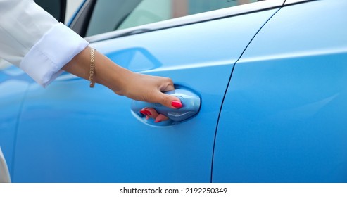 Well-cared Woman Hand With Pink Manicure Opens Door Of Blue Car With Black Leather Cabin. Woman Driver Shows Newest And Attractive Cabin Of Car