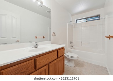A welldesigned bathroom featuring essential items such as a sink, toilet, bathtub, and a mirror for convenience and functionality
