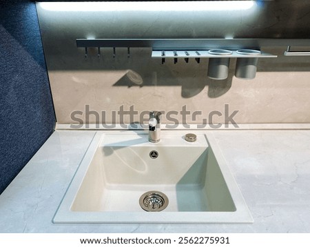 A welldesigned kitchen sink featuring a functional drain and an appropriately designed faucet, all set on a sturdy, highquality countertop, is absolutely essential in any culinary space