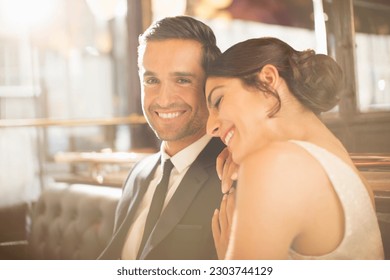 Well-dressed couple hugging in restaurant