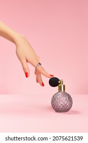 Well-groomed female hand with a ring touch perfume in retro bottle Trendy fashion accessories.