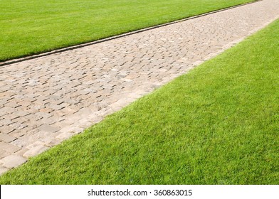 Well-groomed lawns with paved path