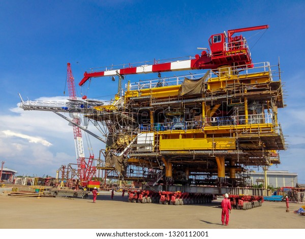 Wellhead offshore platform or topside moving by\
hydraulic car transportation to the barge for sail out to gulf of\
Thailand and installation in oil and gas field. Heavy equipment in\
petroleum industry