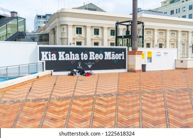 WELLINGTON, NEW ZEALAND - OCTOBER 1; Homeless Couple Beneath Maori Language Week Sign On City To Sea Pedestrian Bridge In City Sign Translates To Strong Maori  October 1 2018 Wellington New Zealand