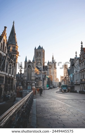 Well-known Ghent city centre with a view of the Belfry of Ghent at sunrise, three towers symbolizing this city. The Golden Hour.
