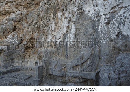 The well-known relief of a Rhodian trireme, warship, cut into the rock at the foot of the steps leading to the acropolis. The relief dates from about 180 BC. Lindos, Rhodes Island, Dodecanese, Greece