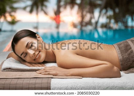 Similar – Image, Stock Photo Young woman and French bulldog on tree trunk at the beach