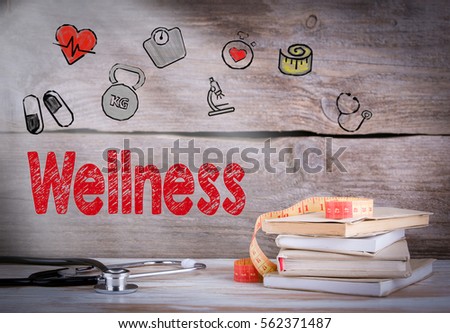 Wellness Concept. Stack of books and a stethoscope on a wooden background