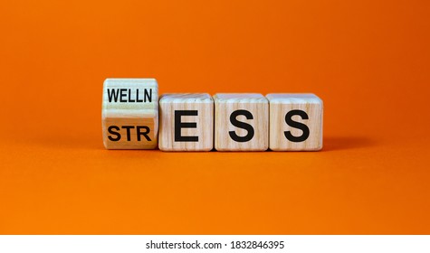 Wellness Instead Of Stress. Turned A Cube And Changed The Word 'stress' To 'wellness'. Beautiful Orange Background. Concept. Copy Space.