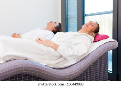 Wellness - a man and a young woman relaxing after sauna, they enjoy the silence