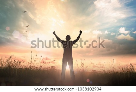Wellness Recovery Action Plan (WRAP) concept: Silhouette of man raised hands at autumn sunset meadow background