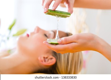 Wellness - woman receiving head or face massage whit aloe Vera in spa
