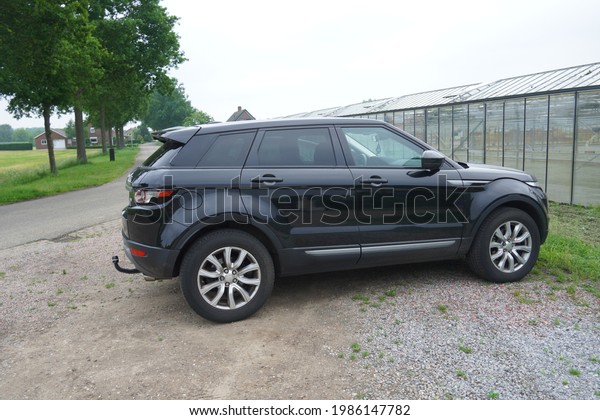 Well,Netherlands-June 05,2021:\
Black Land Rover Range Rover Evoque SD4 five door first generation\
parked in Well,is British luxury crossover SUVs cars produced in\
2011-2018\
