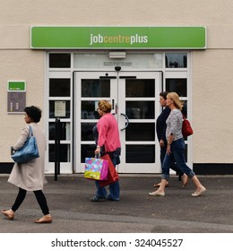 WELLS - AUG 30: People Walk Past A JobCentre Plus Unemployment Office In The City Centre On Aug 30, 2014 In Wells, UK. The Modern Welfare State In The UK Was Founded On The Beveridge Report Of 1942.